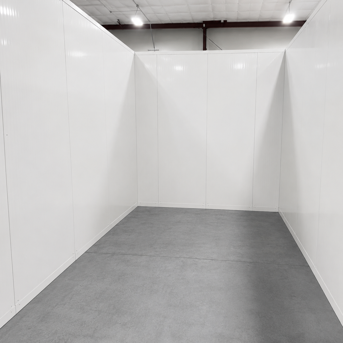 Barr 11'6" x 13'1" x 10'H Walk-In Cold Room without Floor — supplier gallery view 2; Inside of white walk-in cooler unit with closed hinged door, featuring insulated panel walls and a stack of ceiling panels