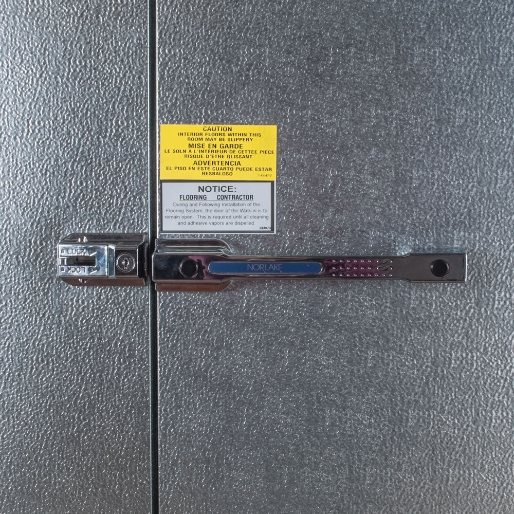 NorlakeFTB8466-CX-M Fast Trak 6' x 6' x 8' 4" Floorless Indoor Walk-In Cooler — supplier gallery view 4; A Norlake Kold Locker metal door with a lock on it.