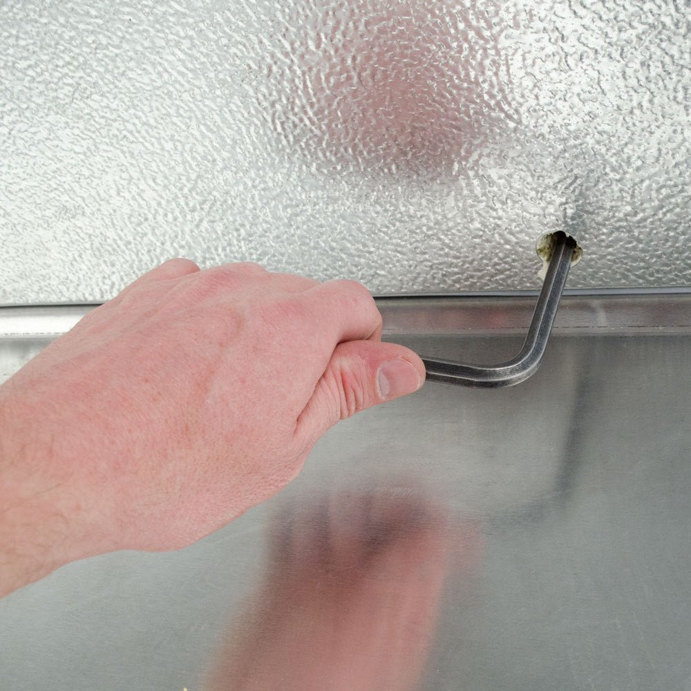 Norlake FTOB87610-CX-M Fast Trak 6' x 10' x 8' 7" Outdoor Walk-In Cooler — supplier gallery view 10; A hand using a key to open a metal door.