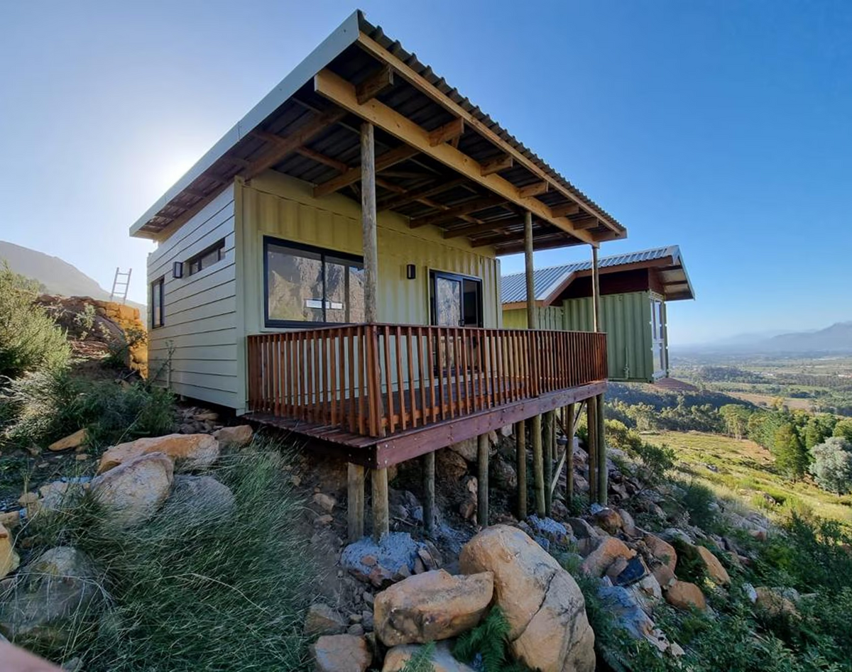 The Studio — Double 6m Container Home with Roof, Deck & Foundations — supplier gallery view 2; The Studio delivered on a hillside with a covered deck