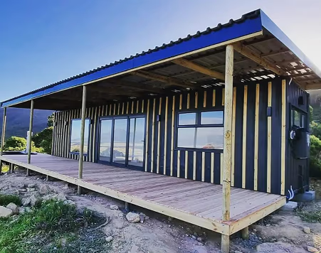 The Den — 12m Container Home with Roof, Deck & Foundations — supplier gallery view 2; The Den built and delivered, with its full roof structure and pine deck